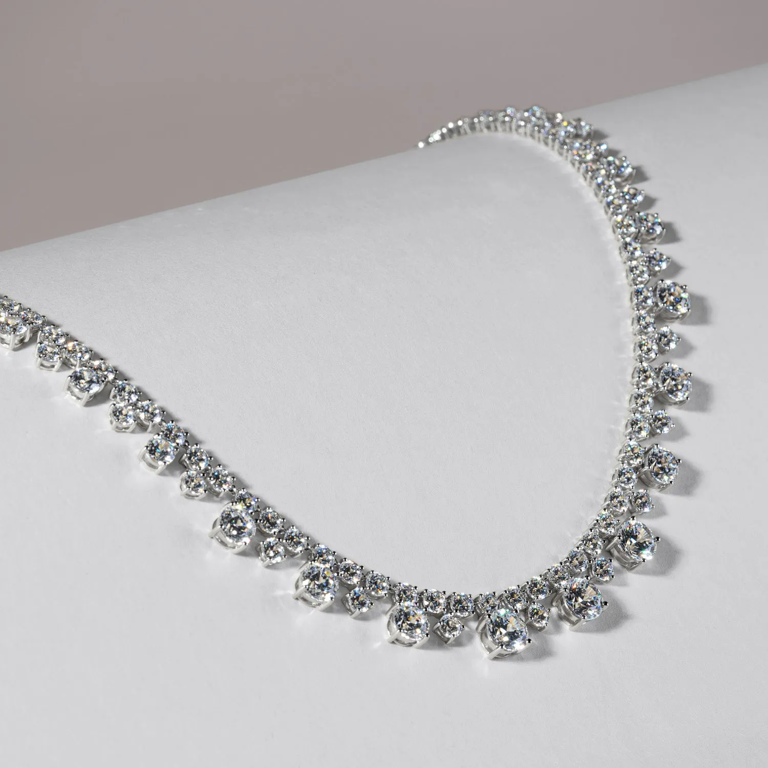 100 Cuts: Silver rhodium plated round cut 100 facet CZ with 16" riviere tennis necklace